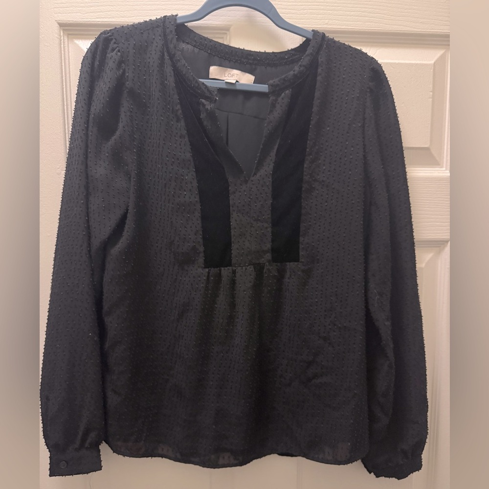 Black loft top with velvet trim detail and textured dot pattern